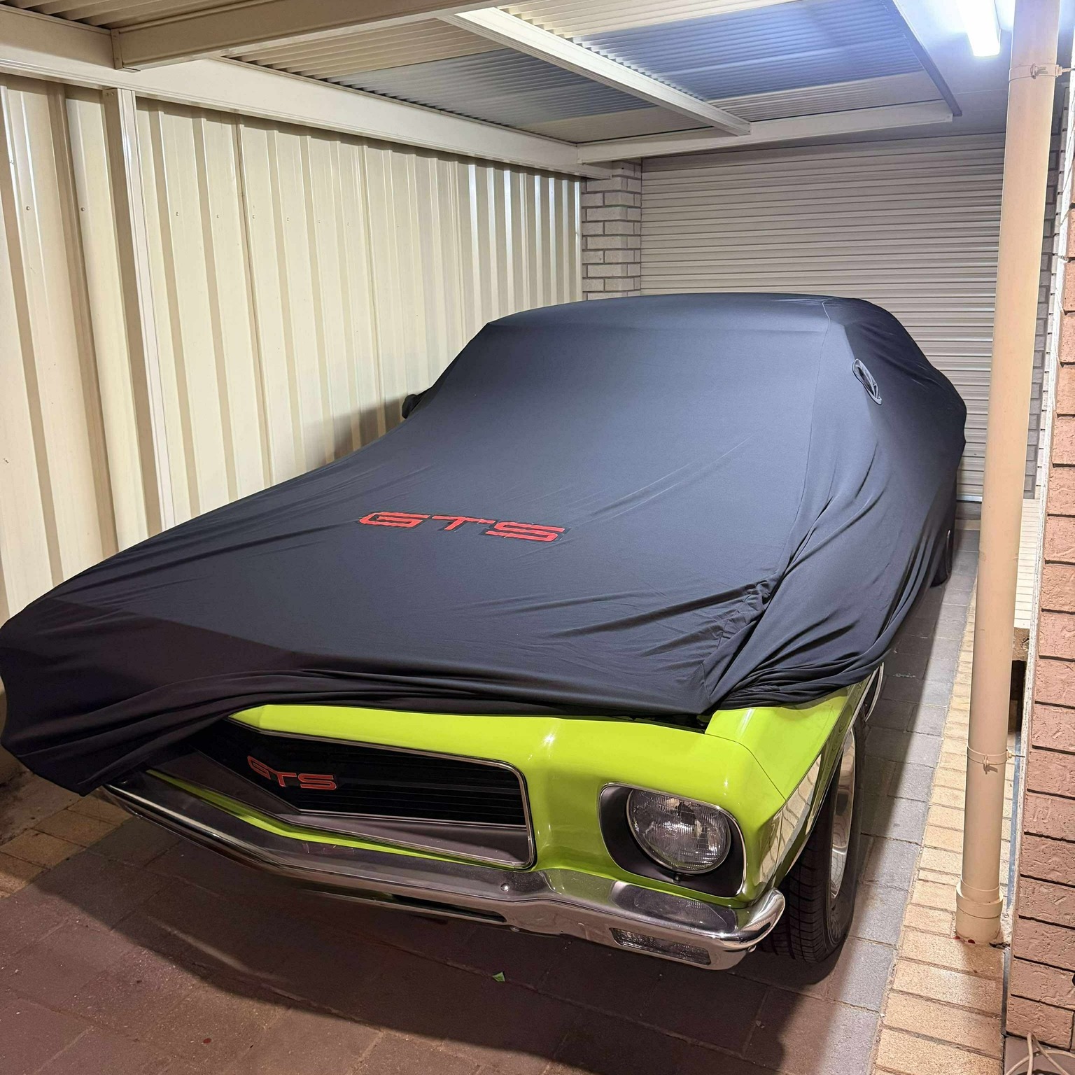Black custom cover with red GTS lettering on a lime green HQ Monaro