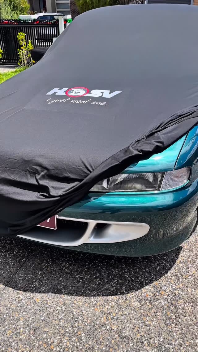Black HSV-branded cover on a teal Commodore