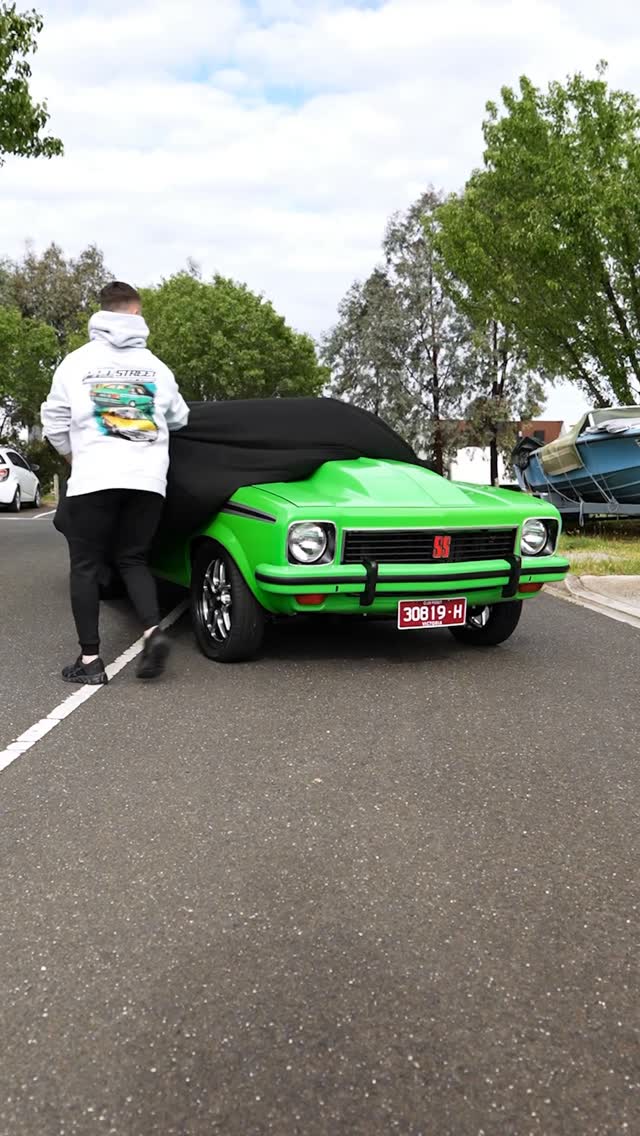 Customer fitting a cover to a green Holden Torana